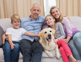oilheat-family-four-dog-couch-sitting-home-123rF-31891416_xxl.jpg